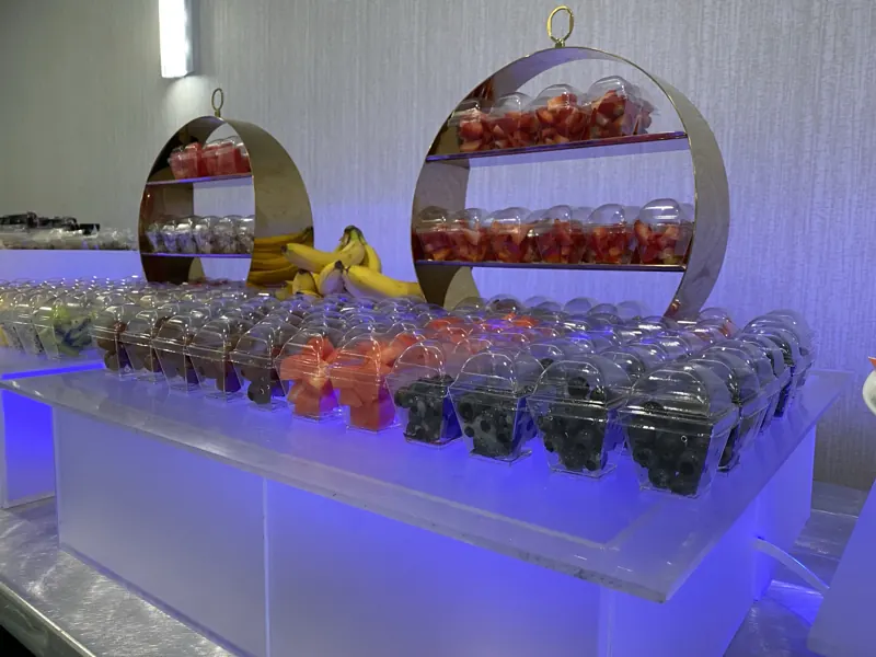 Fresh fruit cups on a gold stand
