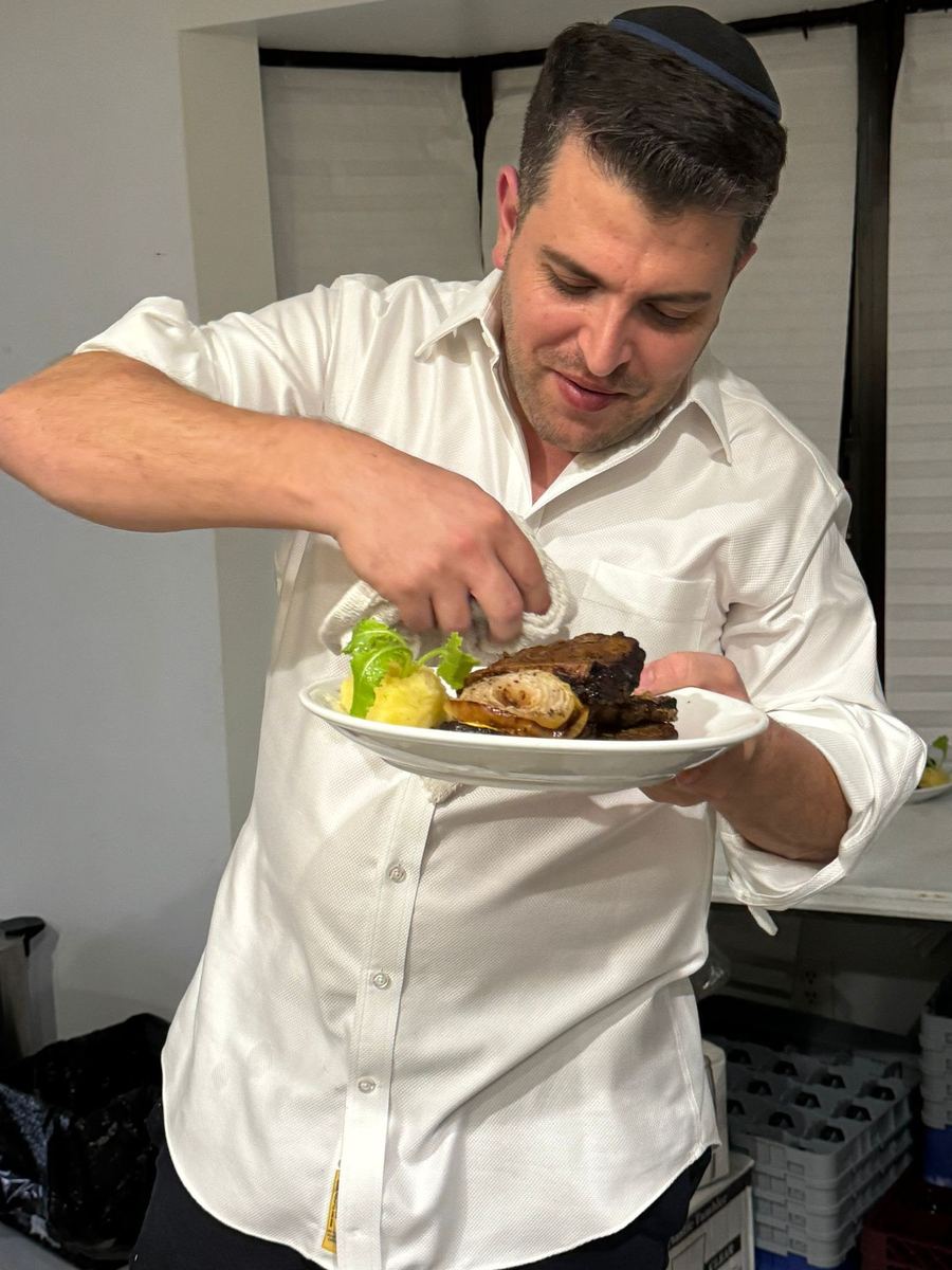 Chef Ari Beck plating a braised brisket dish