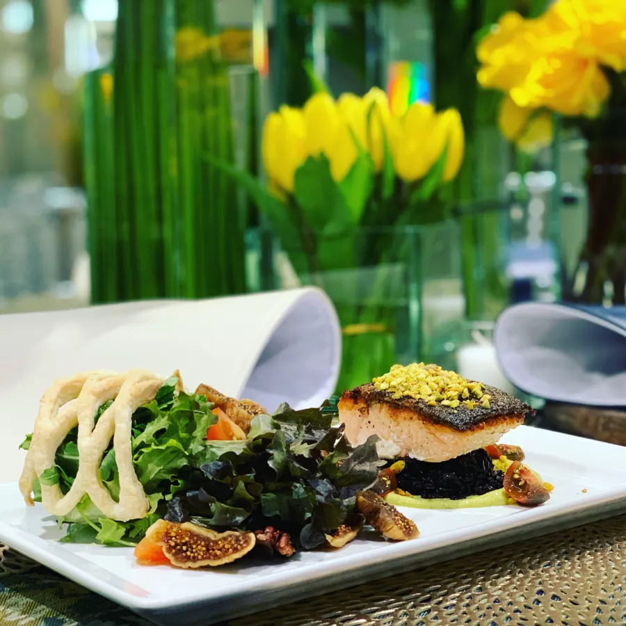 Crispy pistachio salmon on black rice with a fig and greens salad