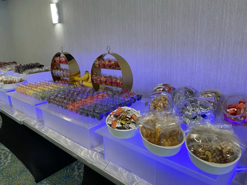 Snack table with fruit cups, nuts and dried fruit