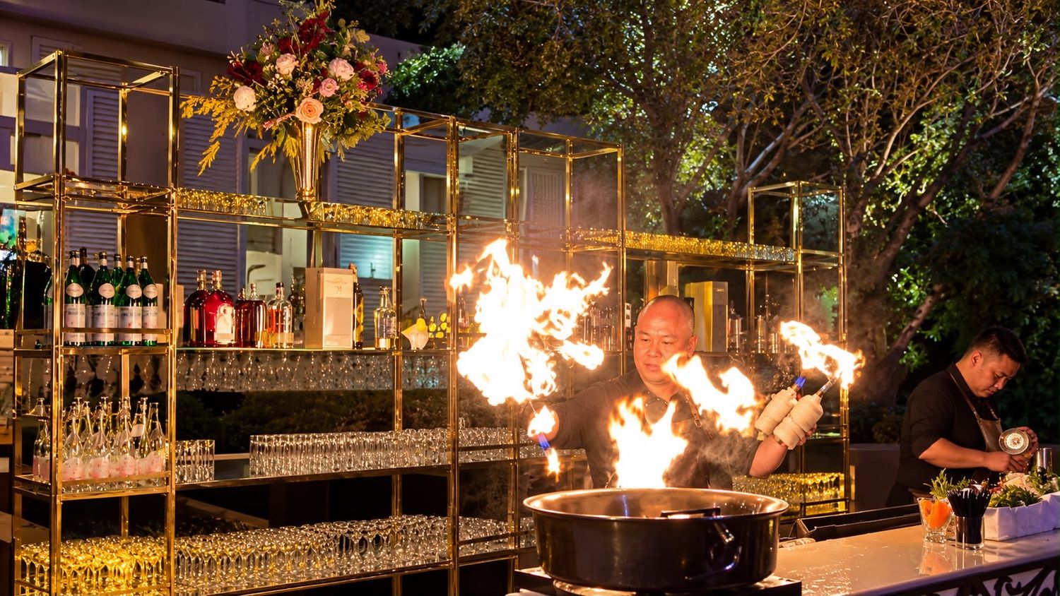 Live flambé bar on a gold bar wall