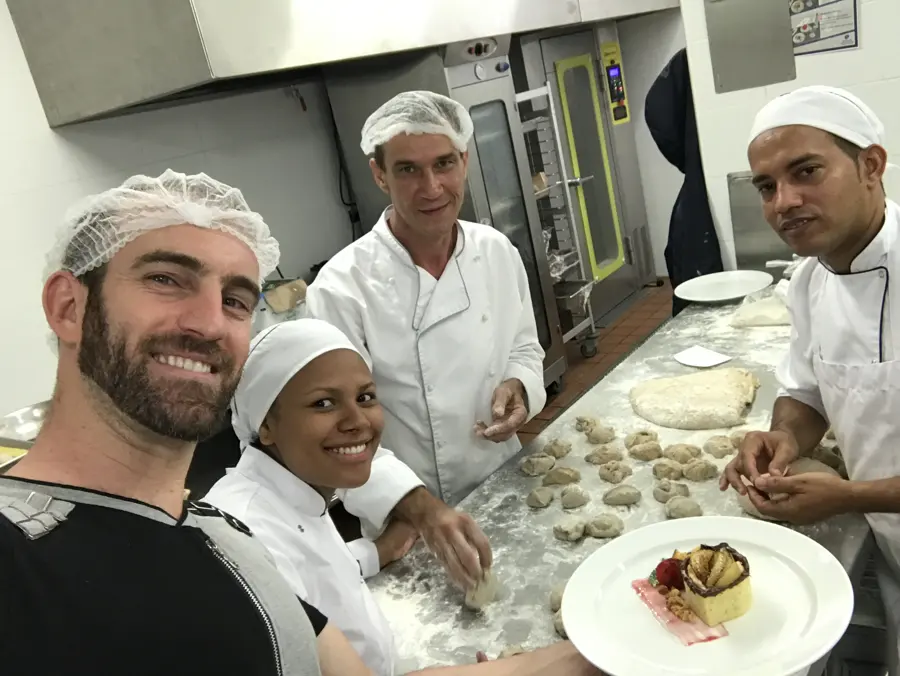 Shaike with the local kitchen team, shaping dough together