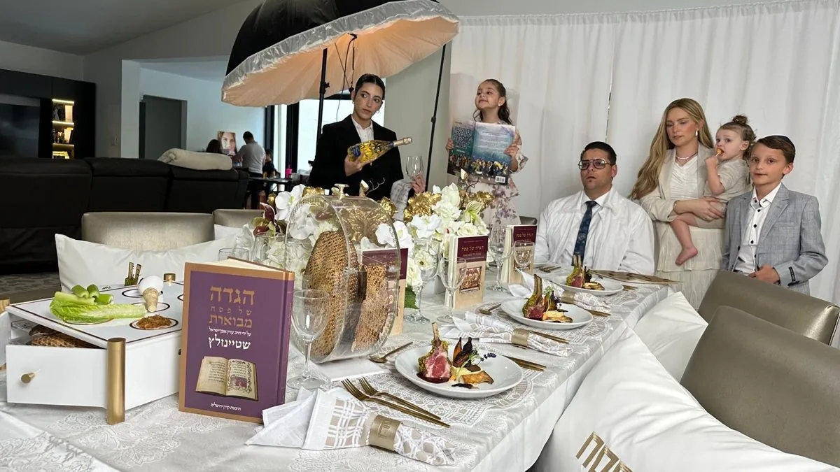 Family Passover Seder table with plated lamb chop, Haggadahs, and matzah