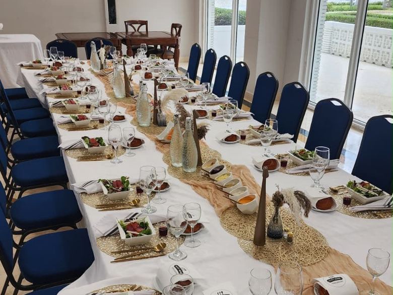 Long table set for dinner in our main room at 4747 Collins Ave