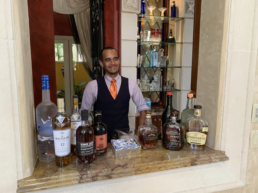 Our bartender behind a fully stocked bar